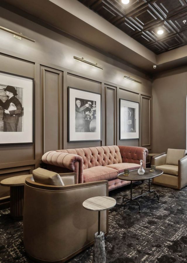 Sophisticated lounge at Rowe Residences featuring plush seating, warm paneling, and modern artwork.