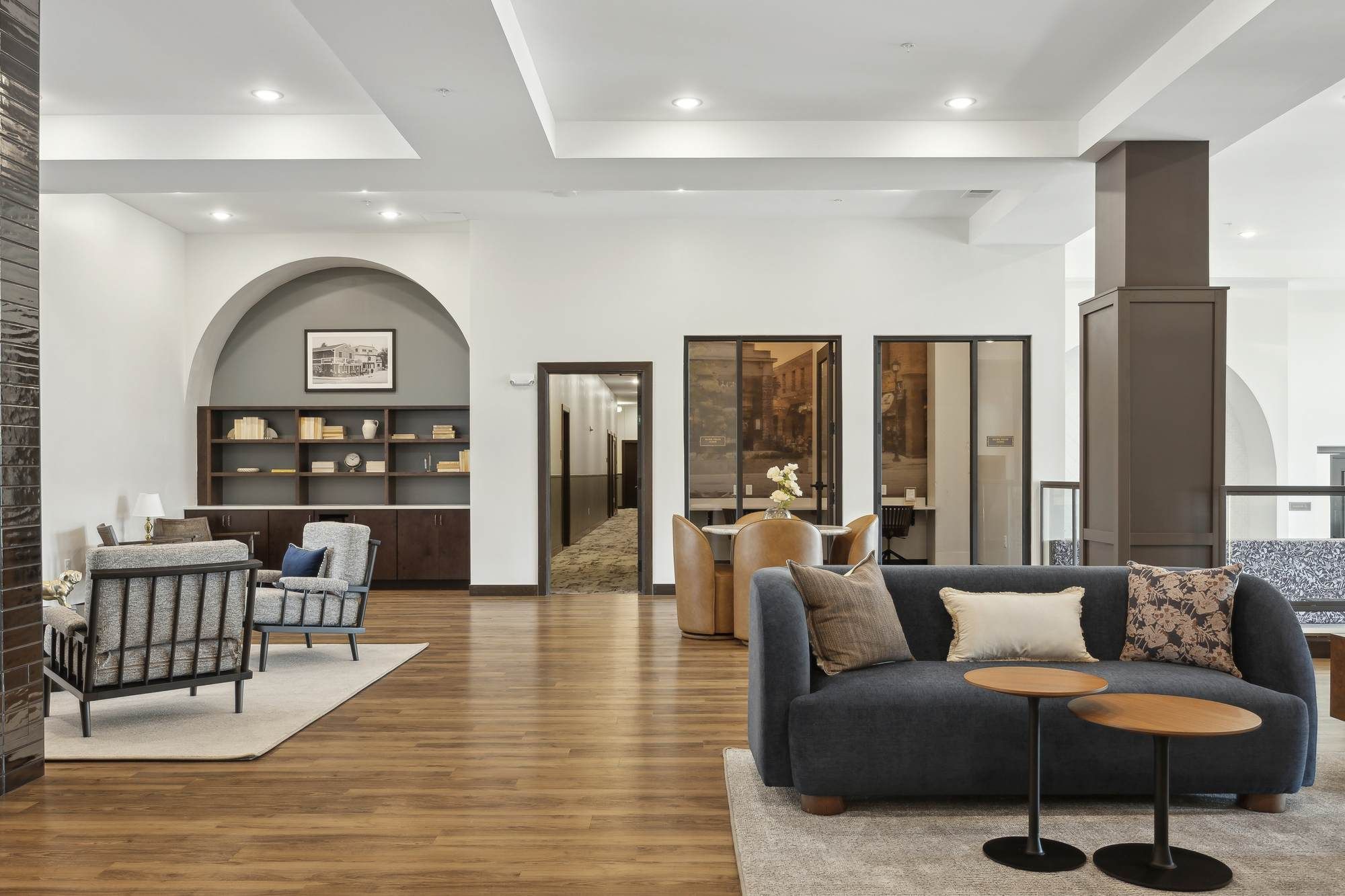 “Modern community lounge at Rowe Residences in Victoria, MN, featuring warm wood flooring, soft seating, and flexible social spaces.