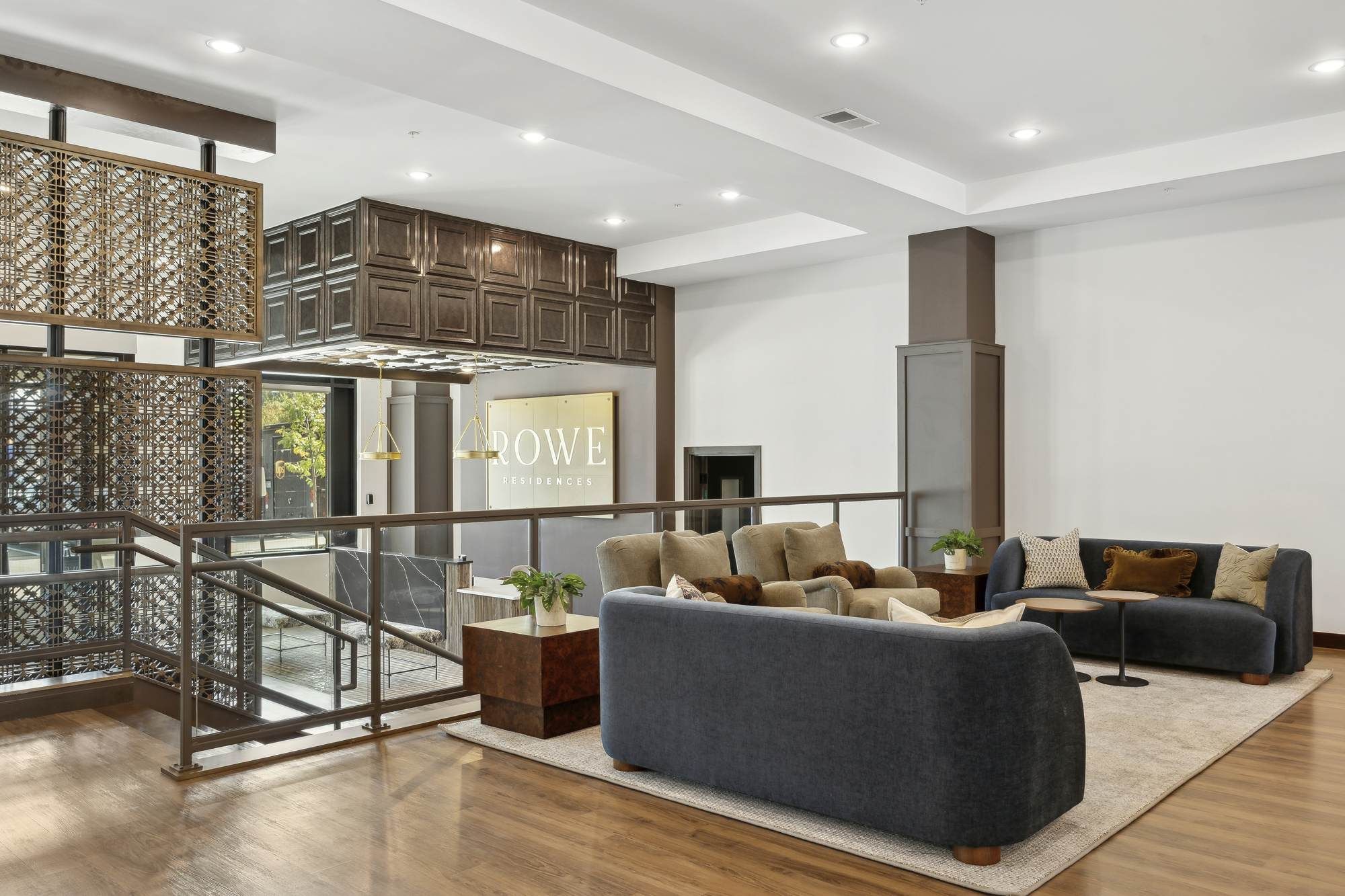 Spacious resident lounge at Rowe featuring modern seating, warm lighting, and a contemporary open design.