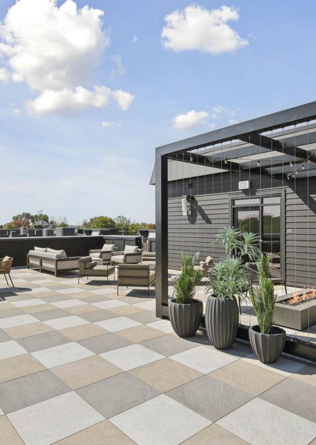 Rooftop terrace at Rowe Residences in Victoria, MN, featuring lounge seating, open sky views, and modern outdoor design.