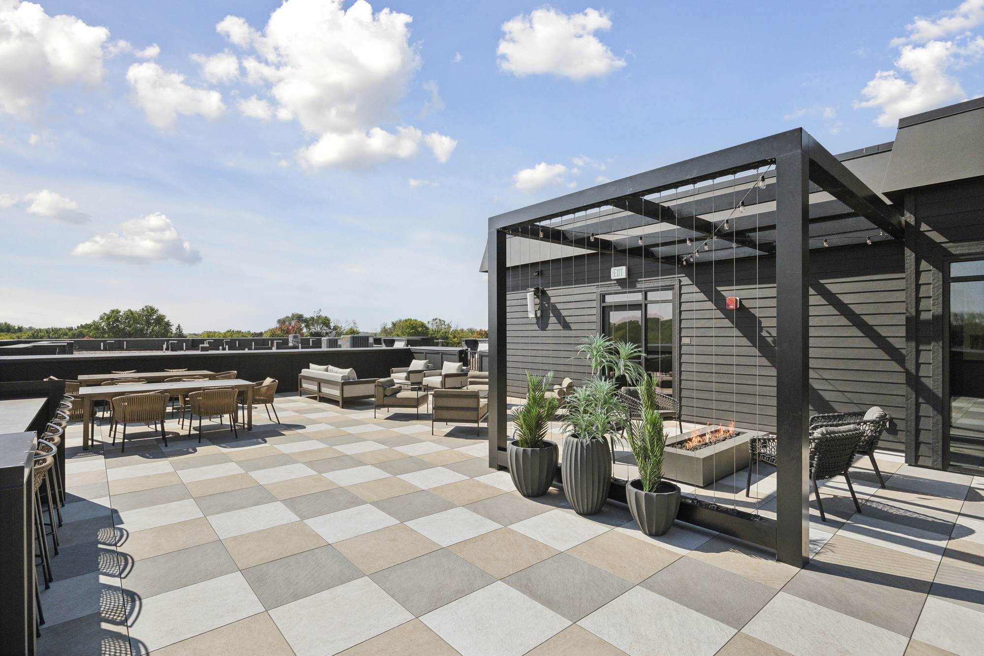 Rooftop terrace at Rowe Residences in Victoria, MN, featuring lounge seating, open sky views, and modern outdoor design.